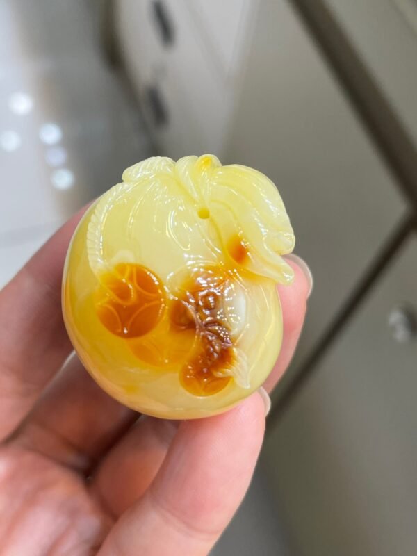 The natural raw mineral white flower cleverly carved and colorful honey wax money bag pendant is approximately 36.6x31.9x29.4mm in size0811790133